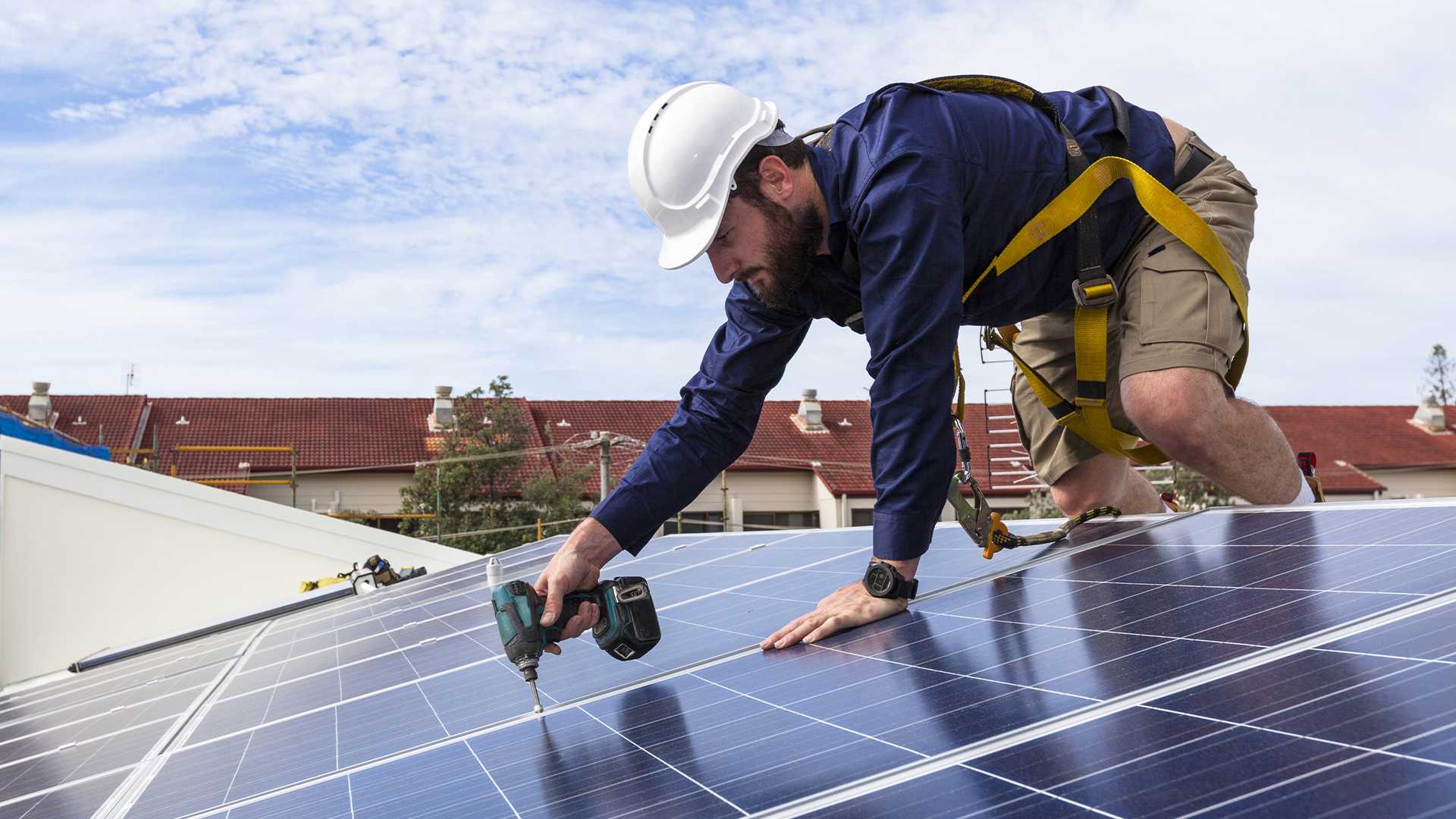 Solarpanele werden auf Dach von einem Handwerker angebracht